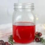 A photo of a jar of cranberry simple syrup set into a decorative text box that reads cranberry simple syrup