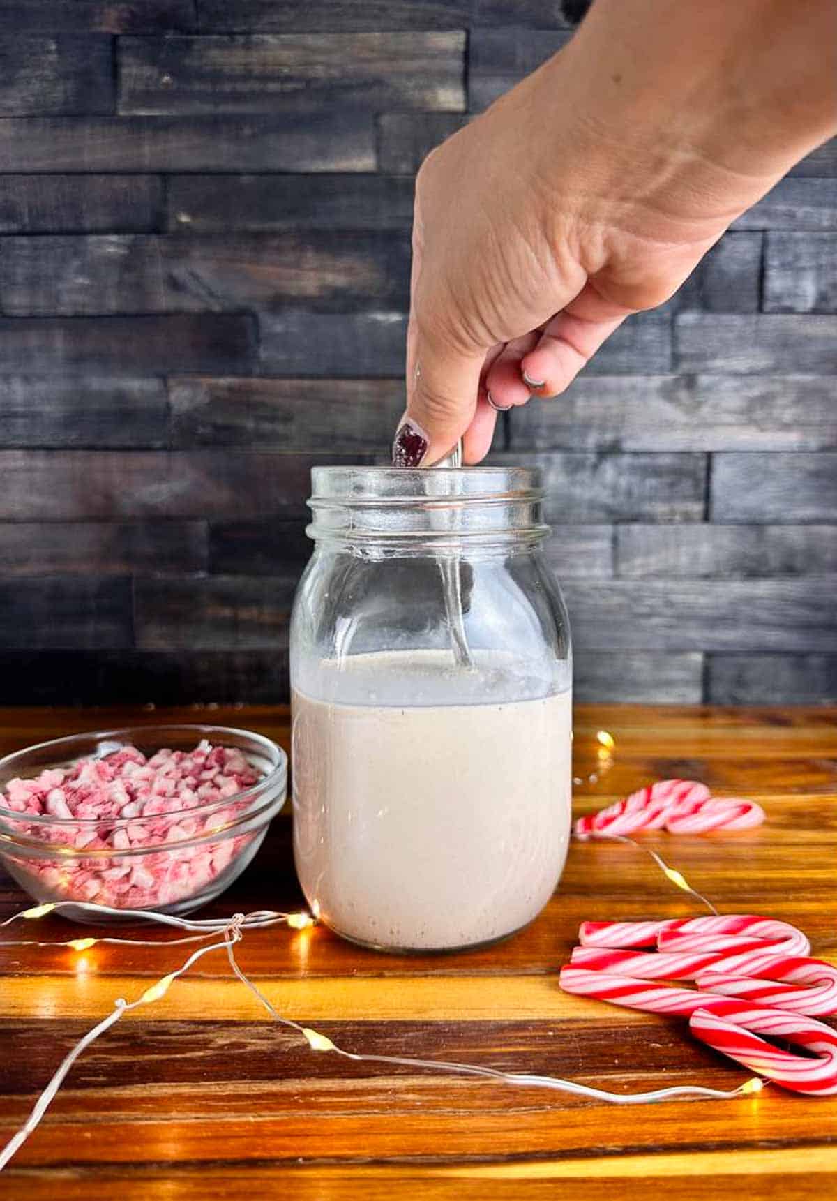 Stir all of the ingredients for peppermint mocha coffee creamer together in a jar.