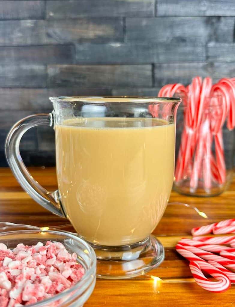 Peppermint Mocha Coffee Creamer in a cup of coffee near candy canes