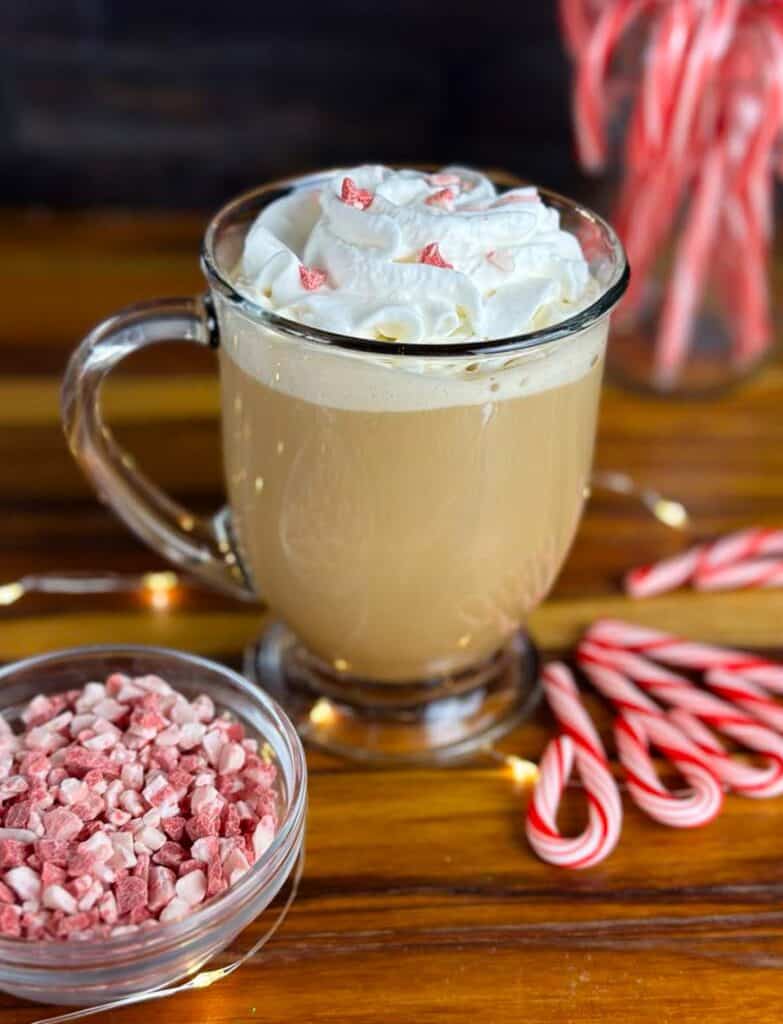 Homemade peppermint mocha coffee creamer makes for a this festive peppermint mocha latte on a counter by candy canes