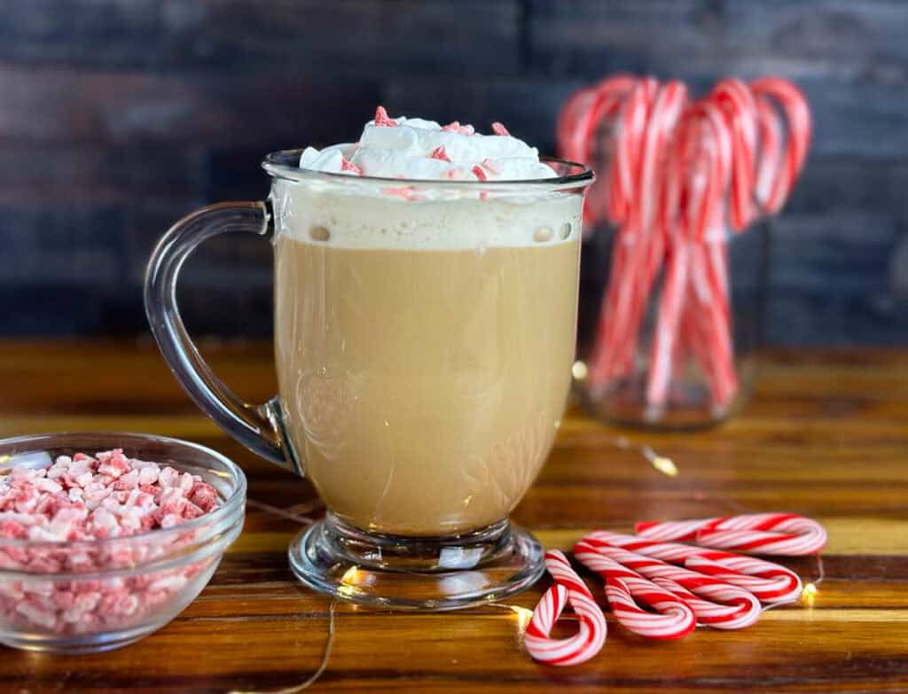 Homemade peppermint mocha coffee creamer makes for a this festive peppermint mocha latte on a counter by candy canes