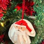 A photo of a Santa handprint salt dough ornaments hanging on a tree set into a text box reading salt dough ornaments