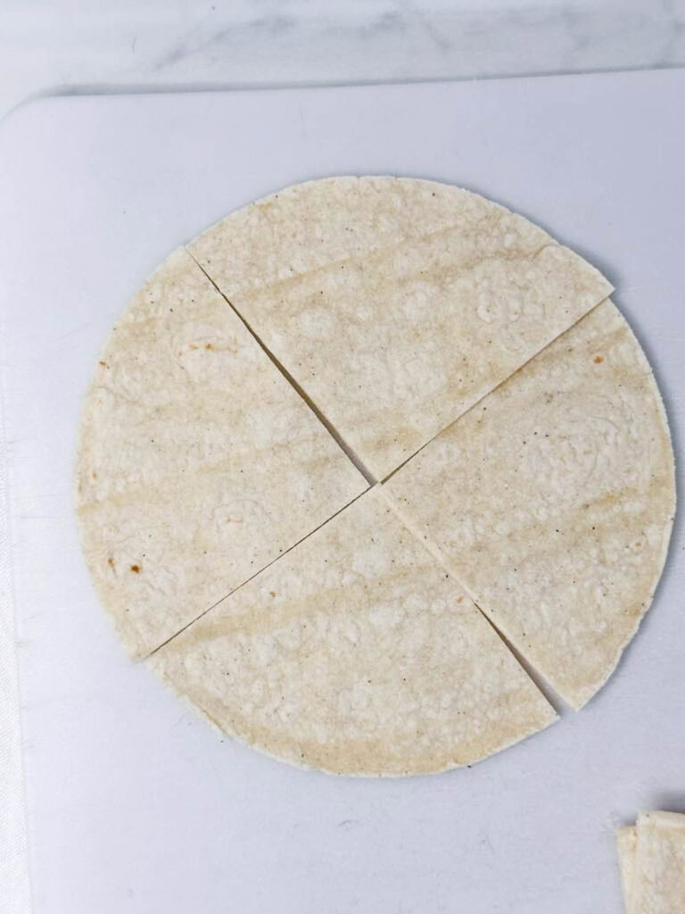 Corn tortilla shell cut into 4 roughly equal pieces.