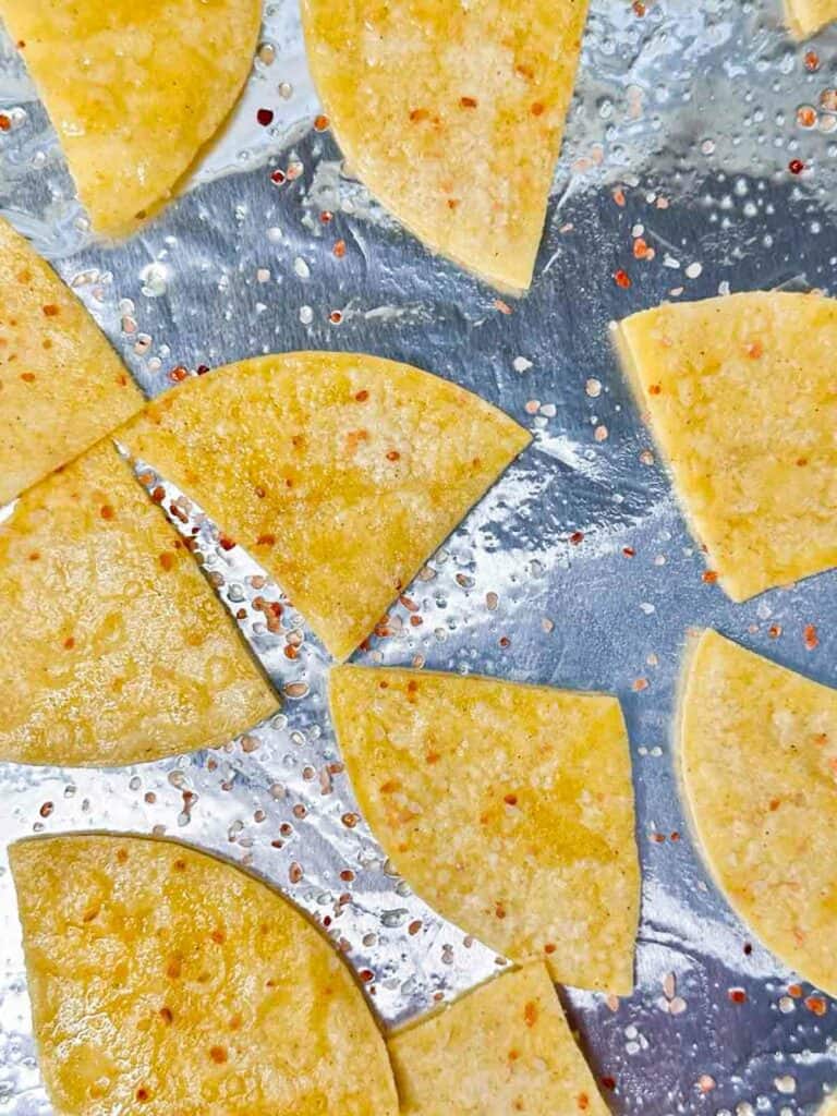 Flipped homemade corn tortilla chips half way through, added more cooking spray and coarse salt.