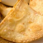 A photo of homemade tortilla chips on a plate with dip set into a decorative text box that reads homemade corn tortilla chips