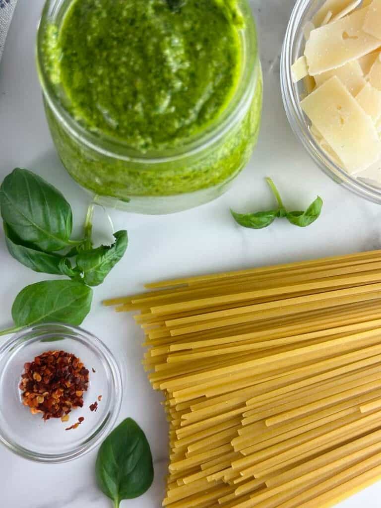 Ingredients for Pesto with Linguine: Linguine, Pesto, Parmesan Cheese, Basil, and Crushed Red Pepper Flakes