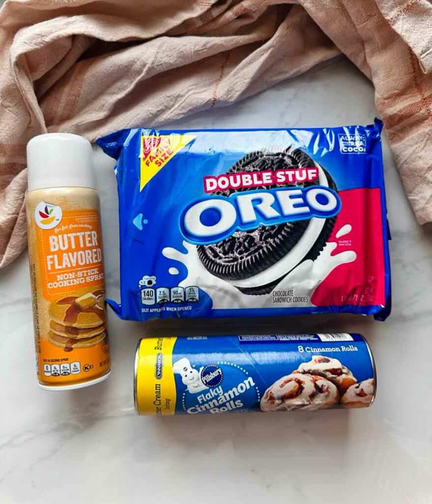 Ingredients for Oreo cinnamon buns: Oreos, cooking spray, and cinnamon rolls.