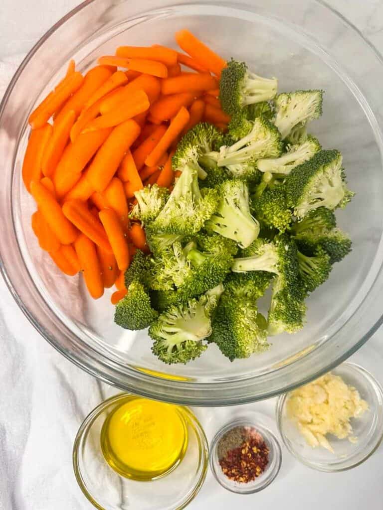 Ingredients for roasted broccoli and carrots: carrots, broccoli, olive oil, red pepper flakes, and fresh garlic