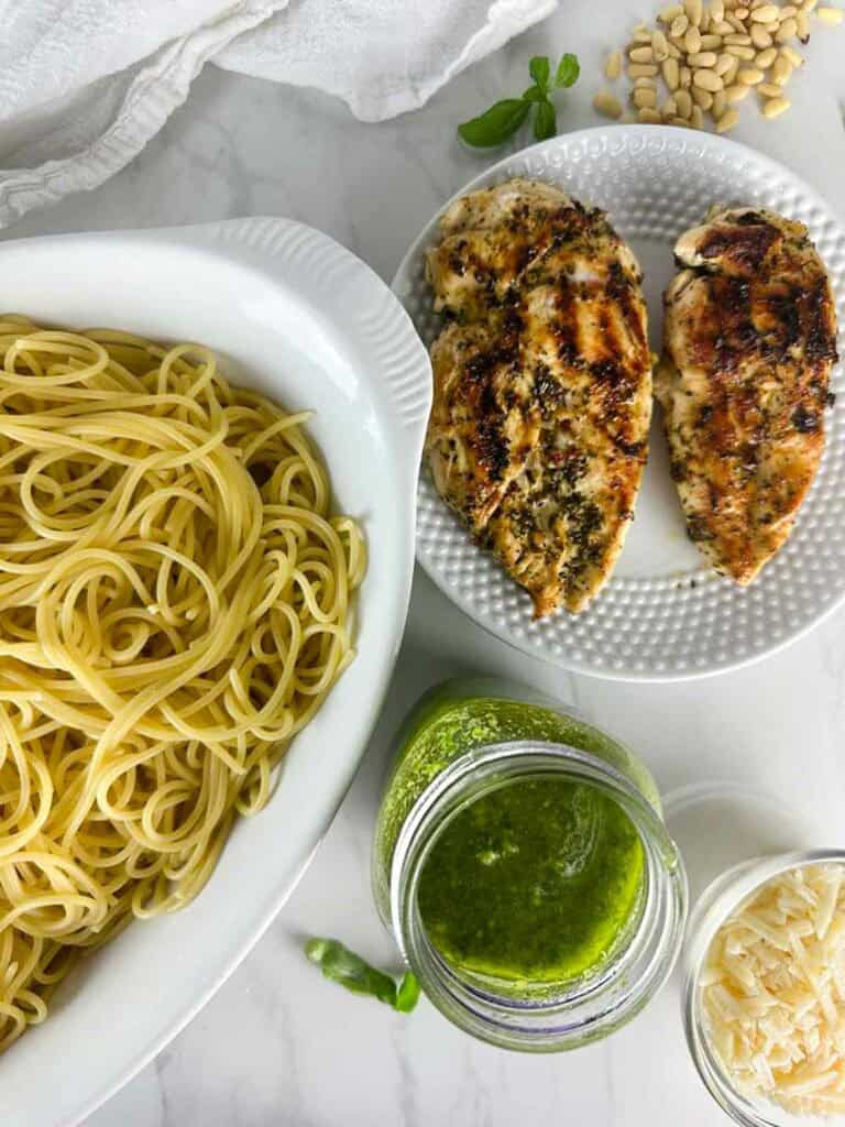 Ingredients for Chicken Spaghetti Pesto: Grilled Italian Chicken, Pesto, Spaghetti, Parmesan Cheese, and Basil