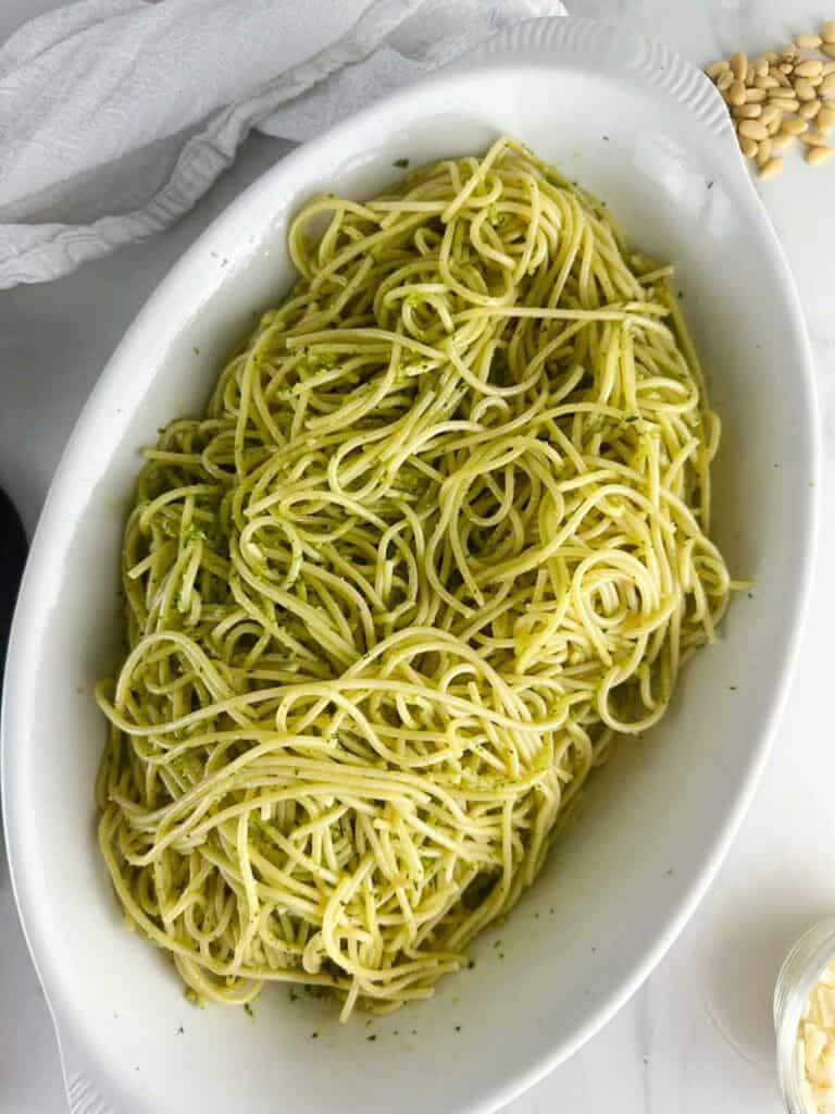 Toss the cooked spaghetti with pesto sauce