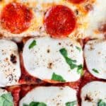 Baked focaccia bread pizza with pepperoni and fresh basil, text reads focaccia bread pizza.