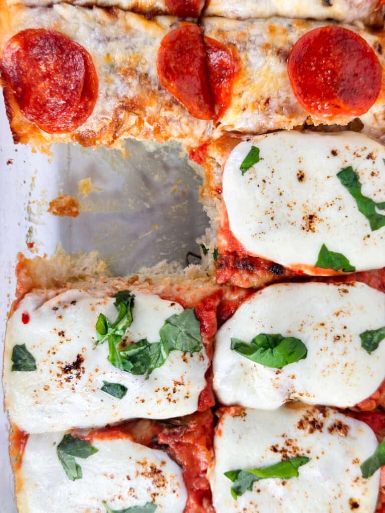 Focaccia bread pizza with a single square removed.