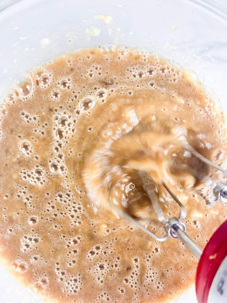 Beat the milk, egg, oil, chocolate, and sugars to the mashed bananas