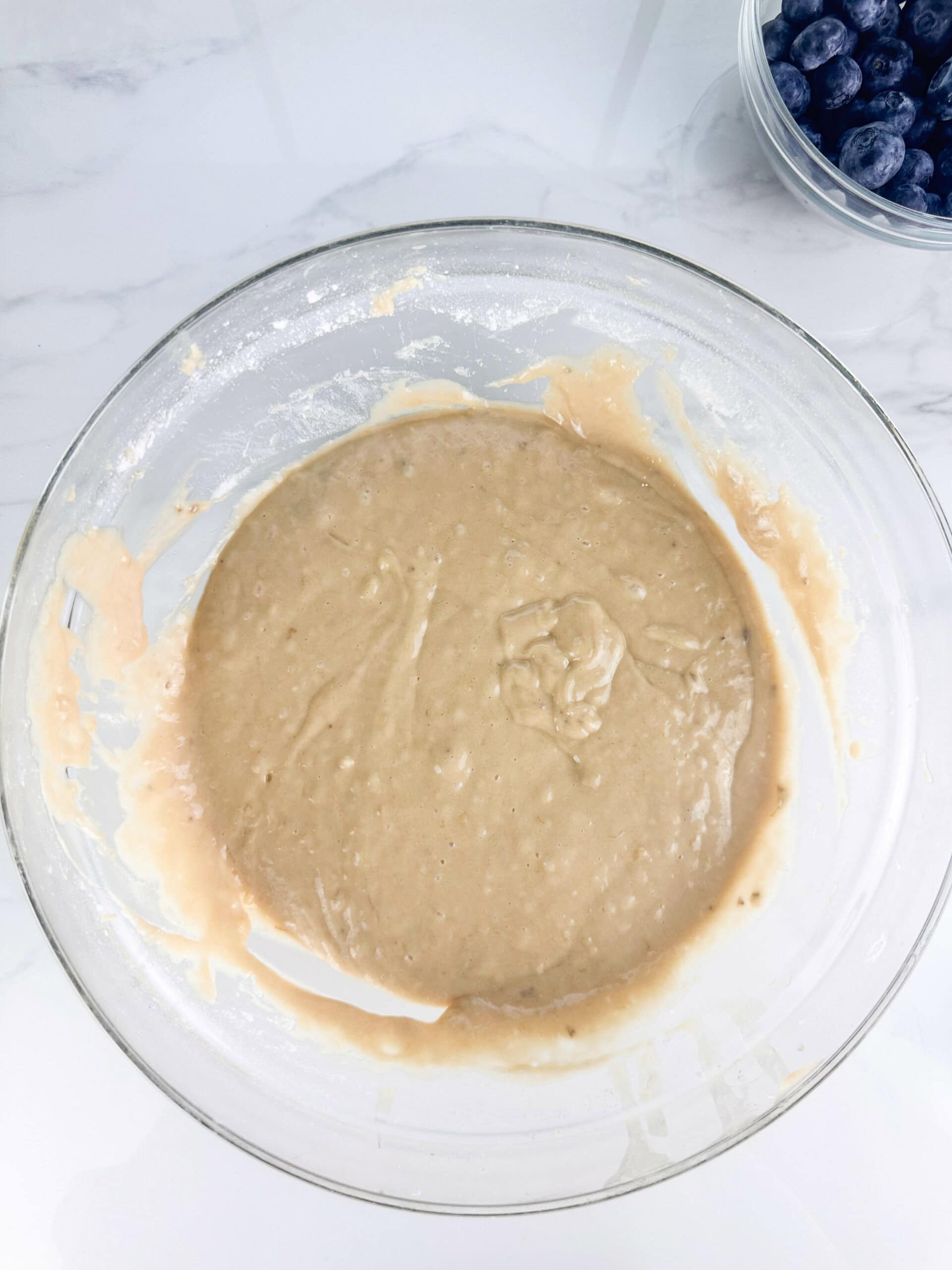 the blueberry banana nut bread batter in a glass bowl