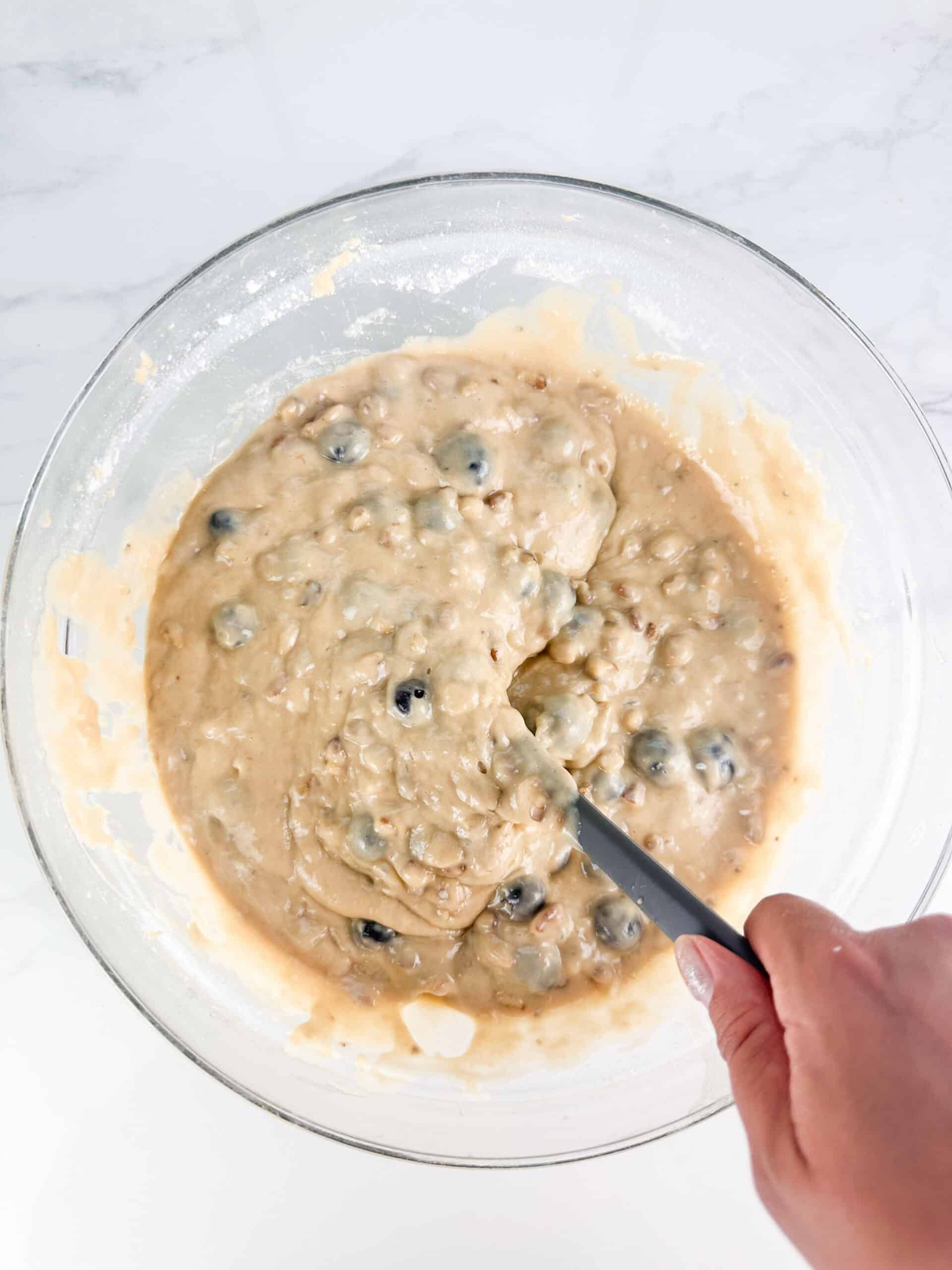 Fold the blueberries and chopped walnuts into the batter until just combined