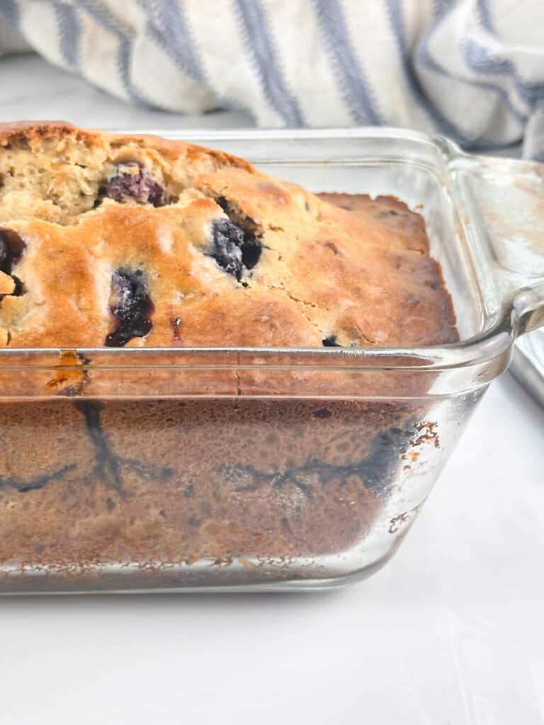 Blueberry banana nut bread in a glass loaf pan