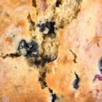 a photo of blueberry banana nut bread with a text overlay reading blueberry banana nut bread seasonedsprinkles.com