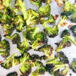 Broccoli and garlic on a baking sheet after baking.