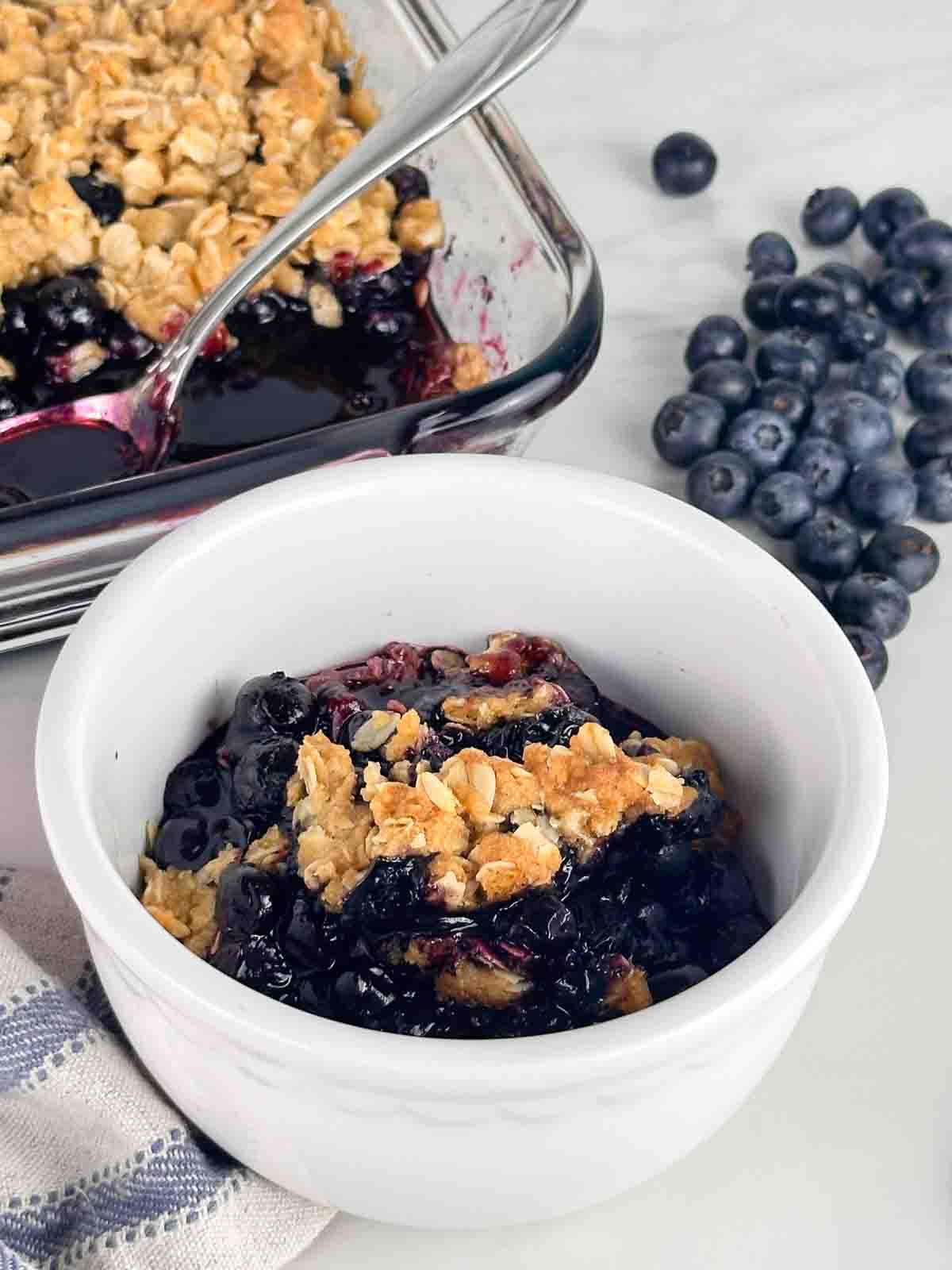 Blueberry crumble in a white bowl.