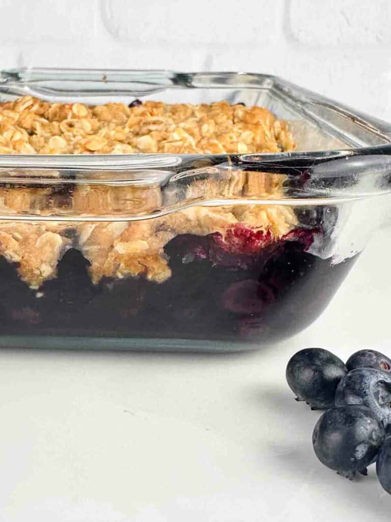 Blueberry crumble in a clear baking dish.