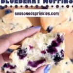 Holding half of a buttermilk blueberry muffin over other blueberry muffins. Text reads buttermilk blueberry muffins, seasonedsprinkles.com.