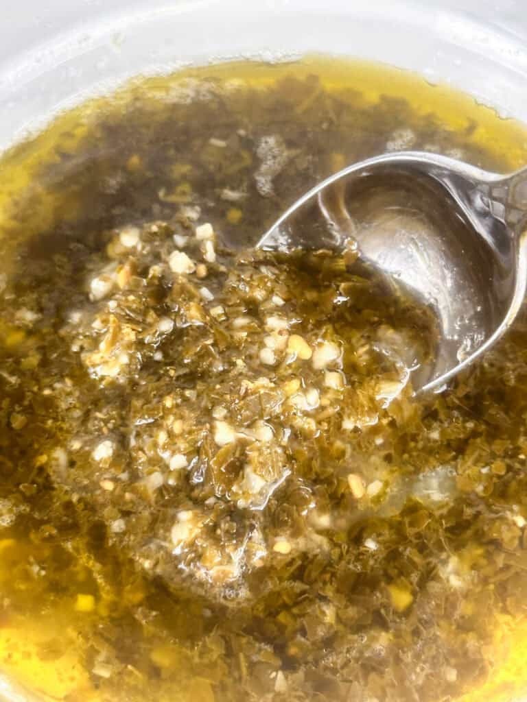 Mixing pesto with lemon juice.