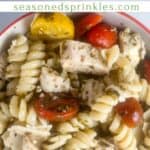 Chicken pesto pasta in a small bowl. Text reads chicken pesto pasta salad, seasonedsprinkles.com