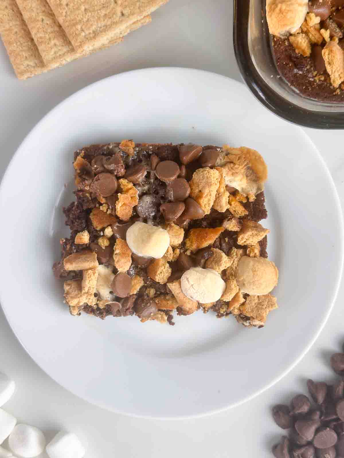 Serving of smores brownies on a white plate.