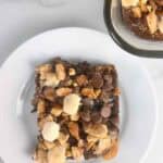 Serving of smores brownies on a white plate.