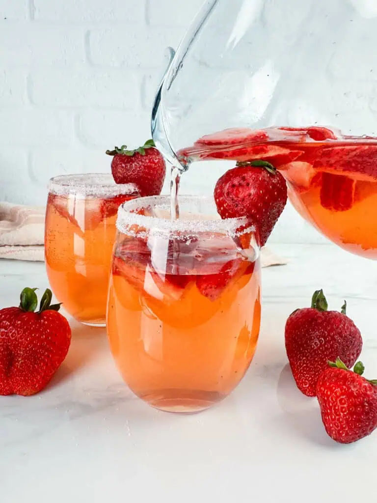 Pouring a glass of strawberry sangria.