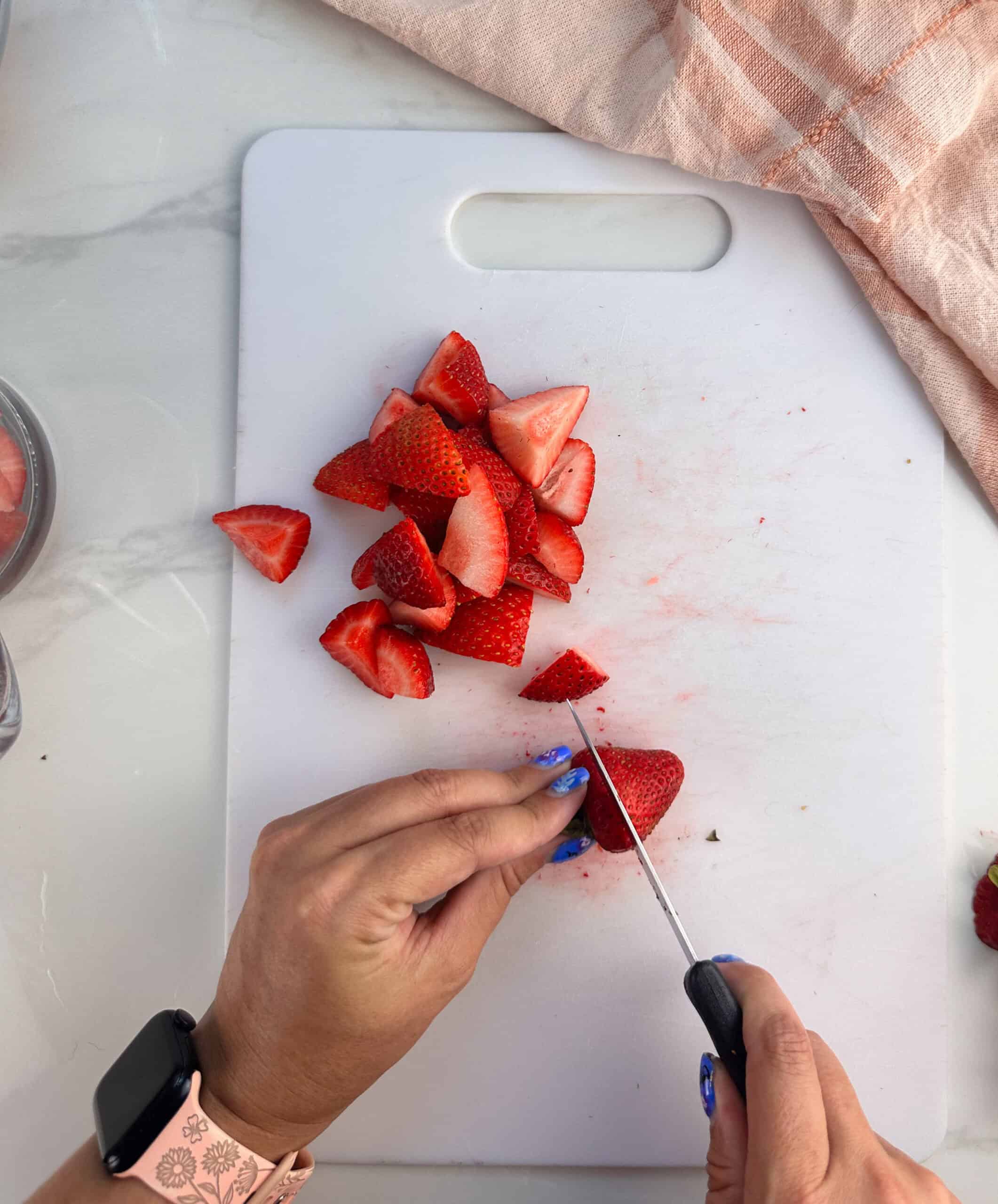 Cut the tops off the strawberries and cut them into quarters