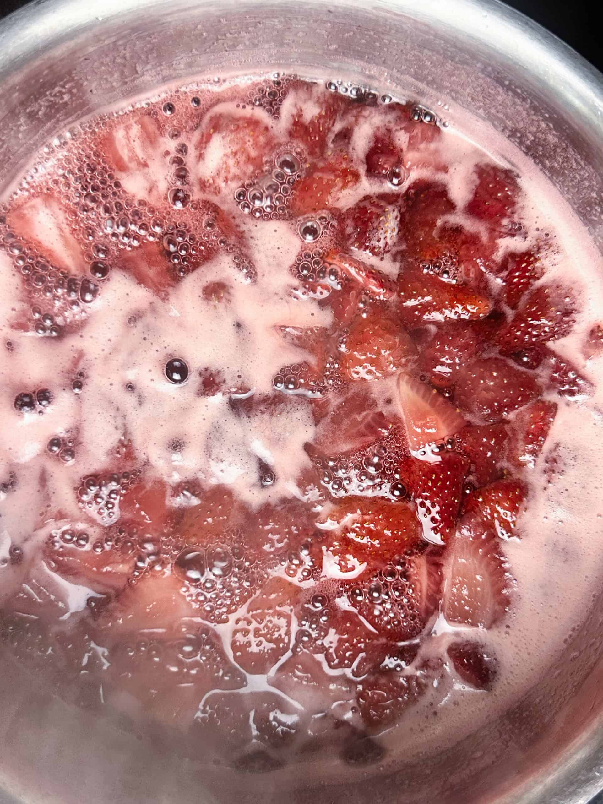 Bring the strawberry simple syrup to a bubble until the strawberries release their juices and turn the syrup red