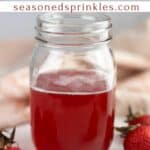 A photo of a jar of strawberry simple simple syrup set into a decorative text box that reads strawberry simple syrup seasoned sprinkles.com