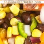 a photo of a close up of black bean and corn salsa with a decorative text box reading black bean corn salsa seasonedsprinkles.com