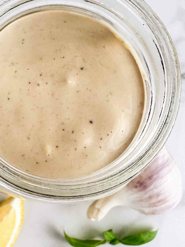 Homemade creamy Caesar salad dressing recipe in a mason jar.