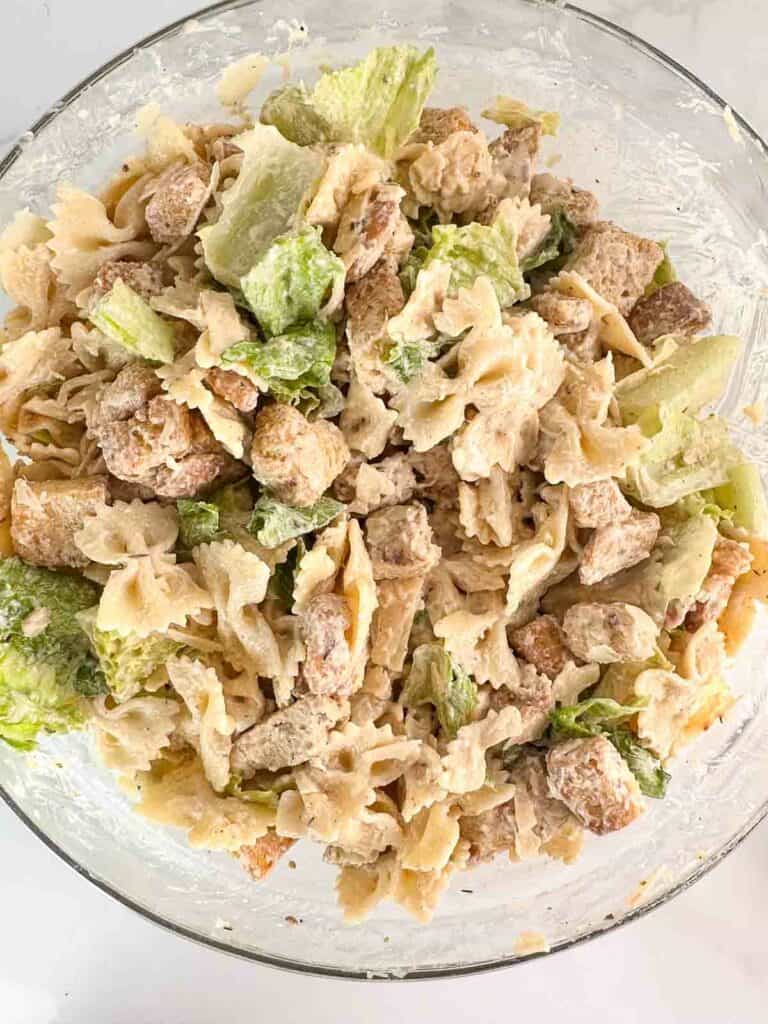 Fully mixed chicken Caesar pasta salad.