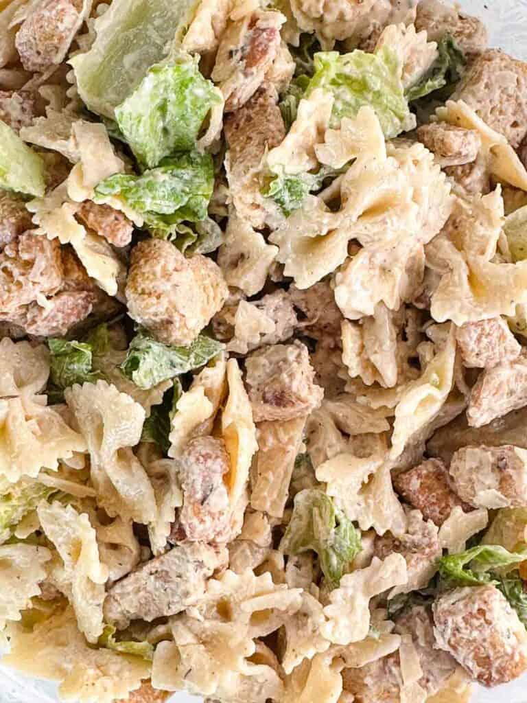 Fully mixed chicken Caesar pasta salad.