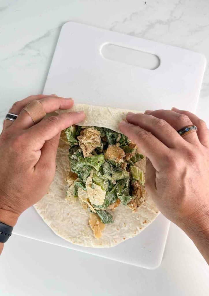 Fold in the ends of the wrap first to seal the wrap when done.