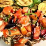 Drizzle of balsamic glaze over grilled bruschetta chicken