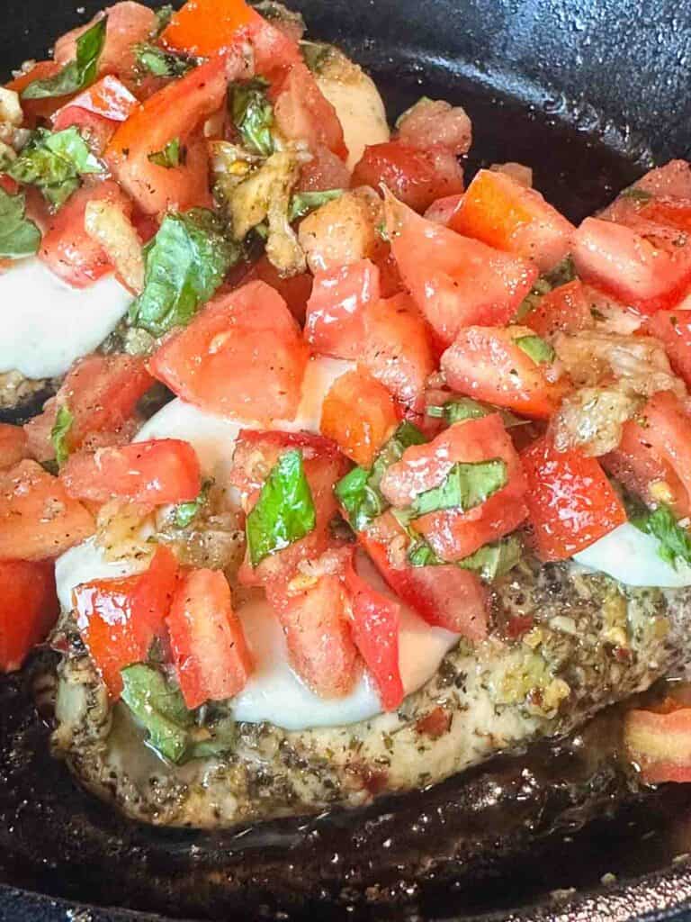 Bruschetta topping added to grilled chicken in the pan once cooled some.