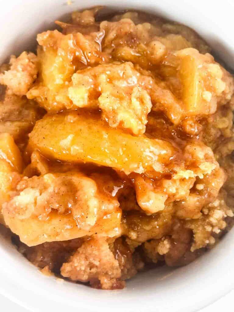 Close up of peach cobbler with cake mix topping.