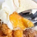 Image of peach cobbler with vanilla ice cream.