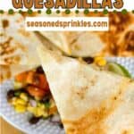 a photo of a piece of cheese quesadilla cut into a wedge collaged into a decorative text box reading cheese quesadilla seasonedsprinkles.com