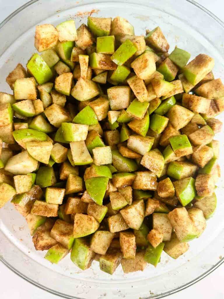 Apple pieces mixed with cinnamon, sugar, and lemon juice.