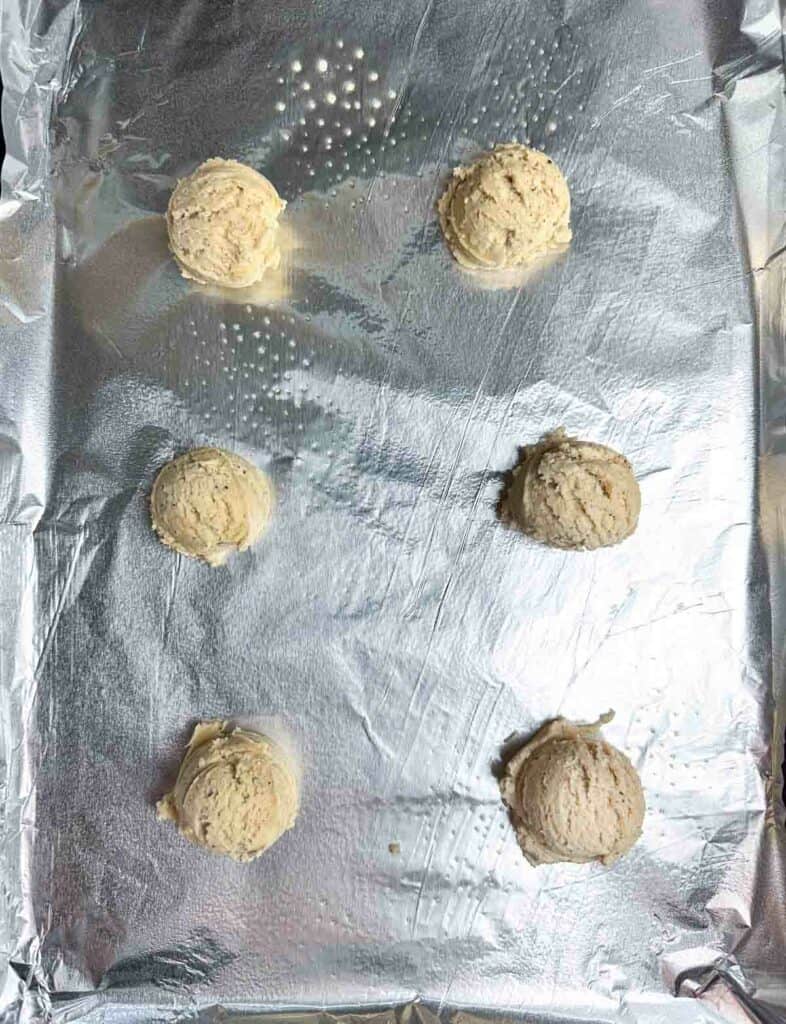 Chai cookies dough on a prepared baking sheet.