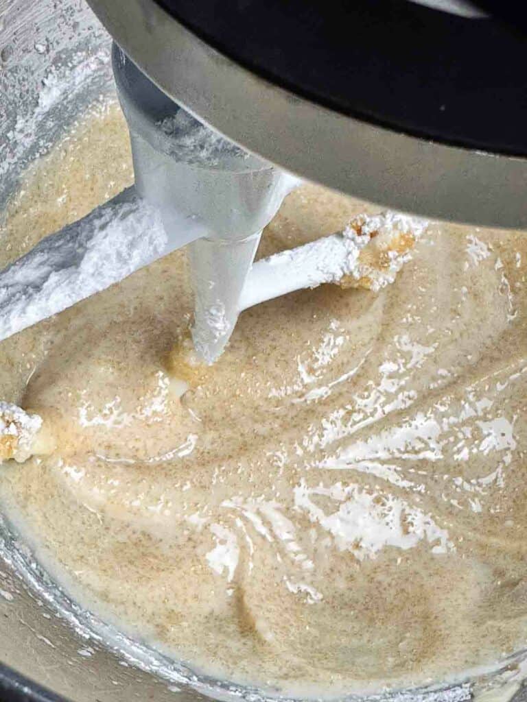 Butter, oil, brown sugar, powdered sugar, and egg in the bowl of a mixer.