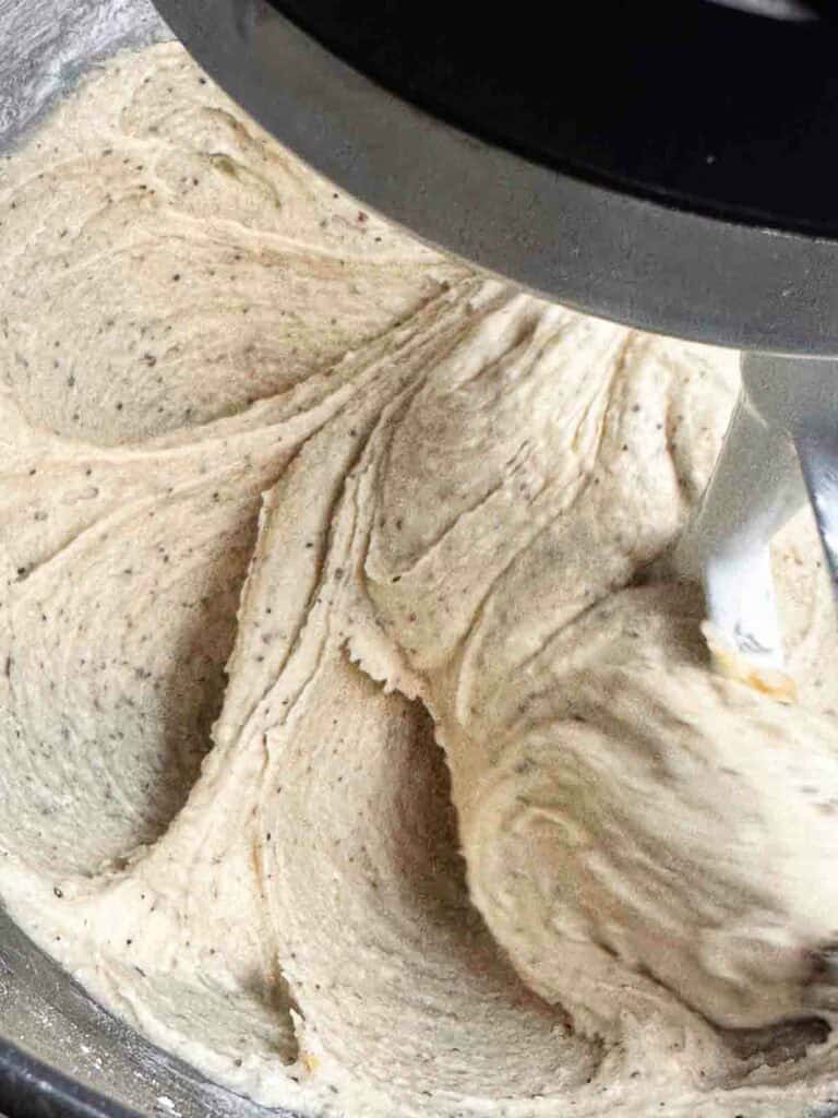 Batter for chai cookies in the bowl of a mixer.