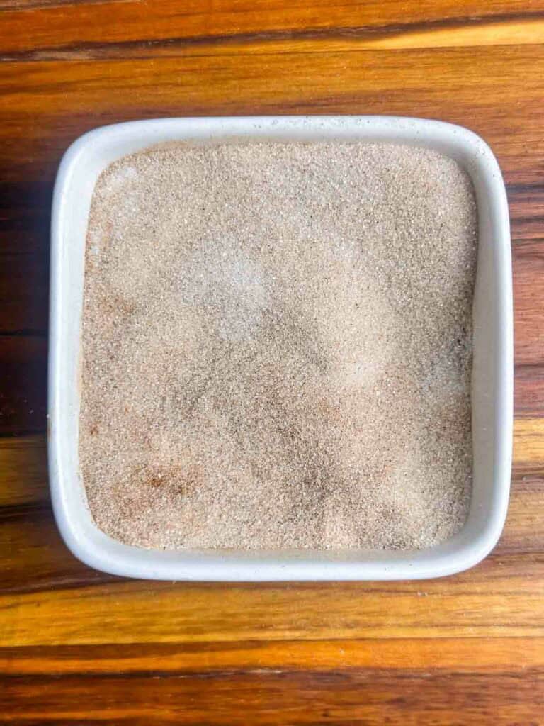 Cinnamon, sugar, and cardamom mixed in a small bowl.