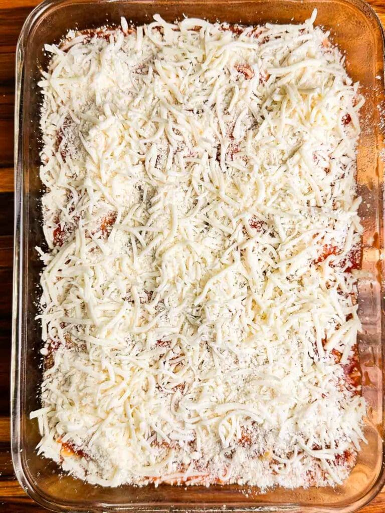 Shredded cheese on in a clear baking dish.
