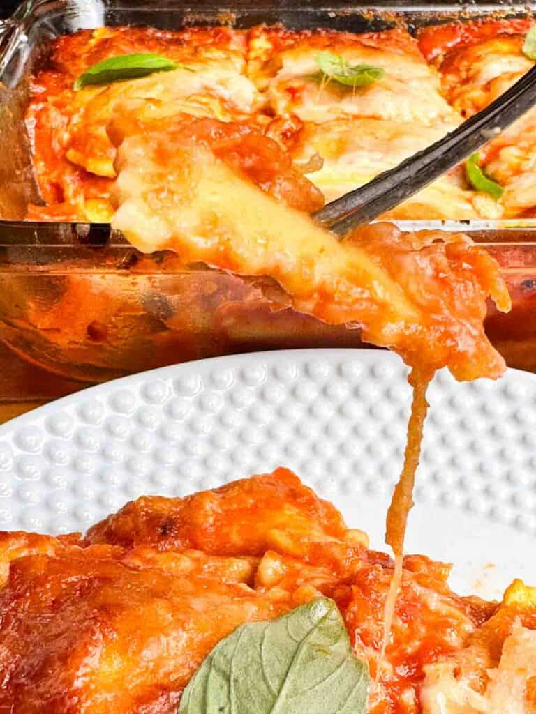 Plate and baking dish with ravioli lasagna.